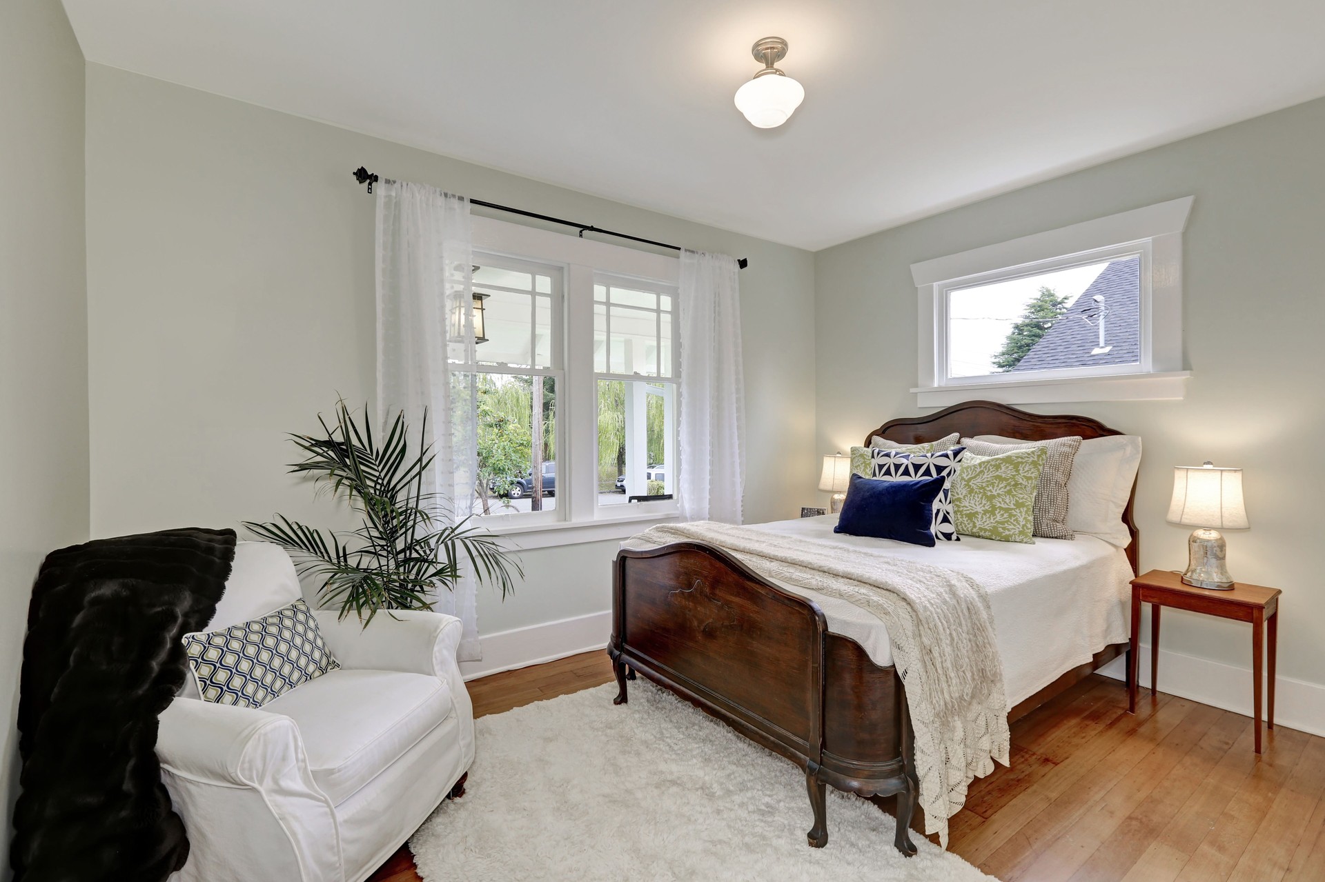 White bedroom interior with vintage wooden bed